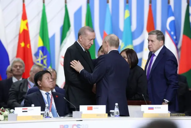 Putin ve Erdoğan BRICS zirvesinde selamlaşıyor.