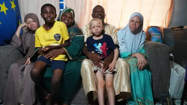 The Sambo family in a group photo with smiles.