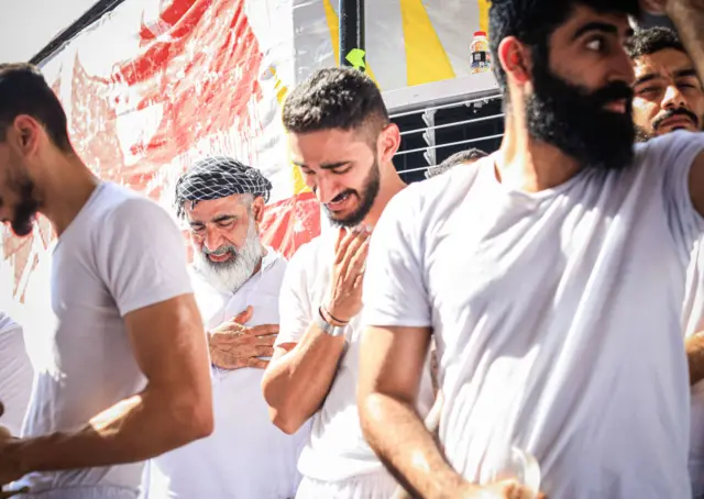 MANAMA, BAHRAIN - AUGUST 09: People attend a mourning ritual on the day of Ashura during the month of Muharram on the Islamic calendar, in Manama, Bahrain on August 09, 2022. Within Muharram month devotees commemorate the martyrdom of Prophet Muhammad's grandson Imam Hussein (Husayn Ibn Ali) along with 72 loyal companions, who was killed in the battle of Karbala in modern day Iraq in 680 AD. (Photo by Ayman Yaqoob/Anadolu Agency via Getty Images)