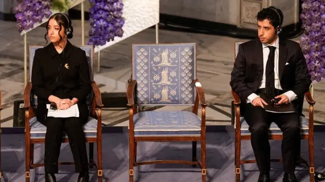 Ali and Kiana Rahmani - next to the empty chair for their mother - live in exile in France