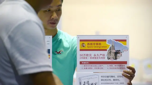 2014年7月4日,北京房地产投资公司的代理人在海外房地产与移民展会上等待投资者。