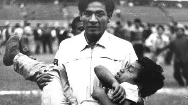 Man carrying injured boy