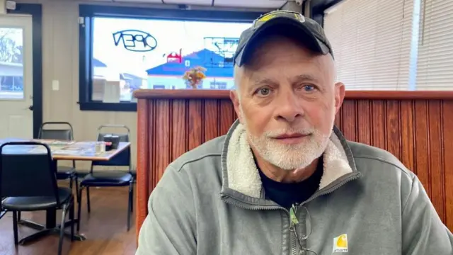Gene Burkholder sentado en un restaurante