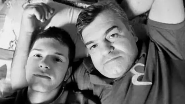 Baba oğulun geçmişte çekilen bir selfie fotoğrafı. İkisi bir yatakta yatıyor. Efe, başını babasının kolunun üstüne koymuş. 