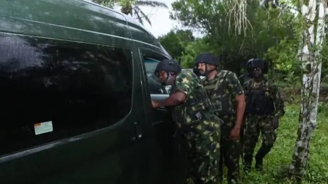 Military officers inside bush wit helmet