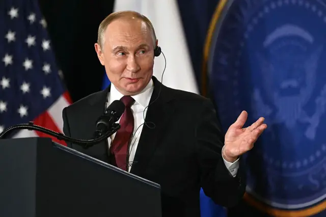 Президент России Владимир Путин жестикулирует во время совместной пресс-конференции с президентом США Дональдом Трампом (вне кадра) после участия в американо-российском саммите по Украине