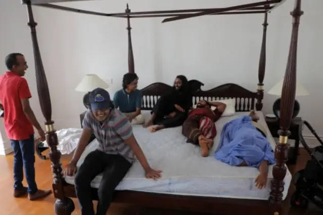 Visitors try out the bed at the Sri Lankan Presidentâs official residence that was stormed by protestors in Colombo, Sri Lanka 