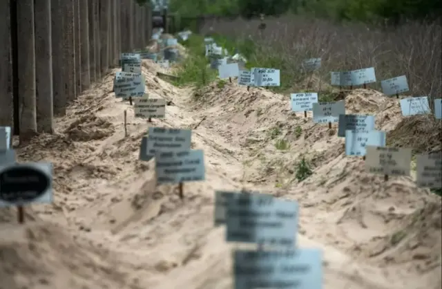 Unmarked graves in Ukraine, where the war continues to exact a devastating toll