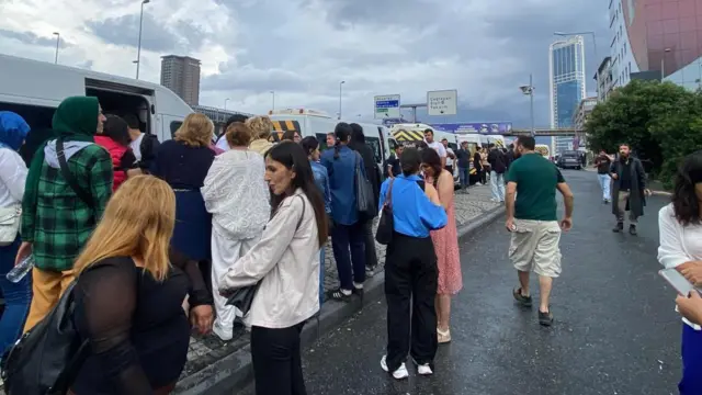 Otobüslerin yanında toplanmış bir kalabalık