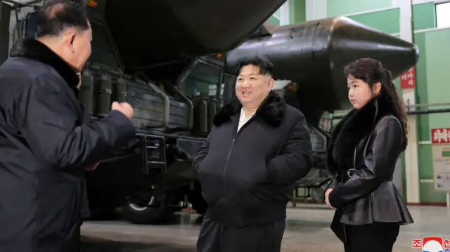 An undated photo released by the official North Korean Central News Agency (KCNA) on 05 January 2024 shows Kim Jong Un and Ju Ae inspecting a missile launcher production facility in an undisclosed location in North Korea