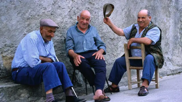 Homens sentados conversando na Sardenha