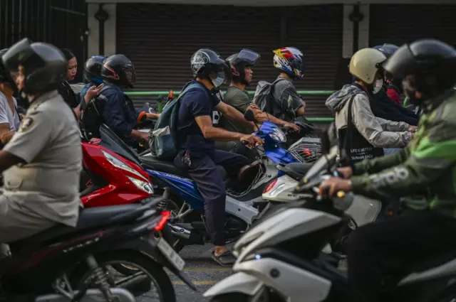 Motorcyclists ride along a street in Bangkok, Thailand, on Wednesday, Jan. 17, 2024