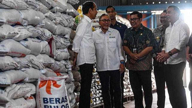 Presiden Joko Widodo (kiri) berbincang dengan Menteri Perdagangan Zulkifli Hasan (kedua kiri) saat meninjau persedian beras serta penyerahan bantuan pangan beras cadangan pangan pemerintah kepada Keluarga Penerima Manfaat (KPM) di gudang Bulog, Cibitung, Bekasi, Jawa Barat, Jumat (16/2/2024).