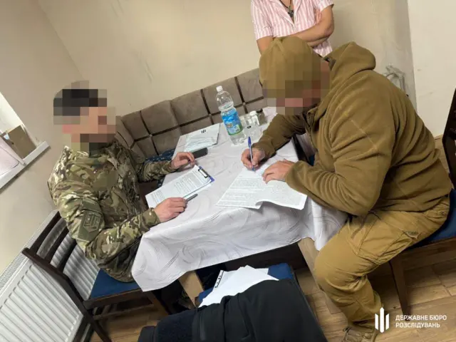 Військові оформлюють документи за столом 