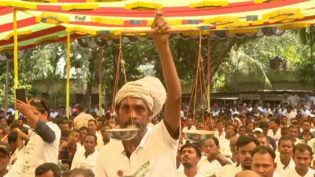 খুলনায় জামায়াতের 'হিন্দু সম্মেলনে' দলটির দাঁড়িপাল্লা প্রতীক হাতে একজন সমর্থক, গতমাসের ছবি