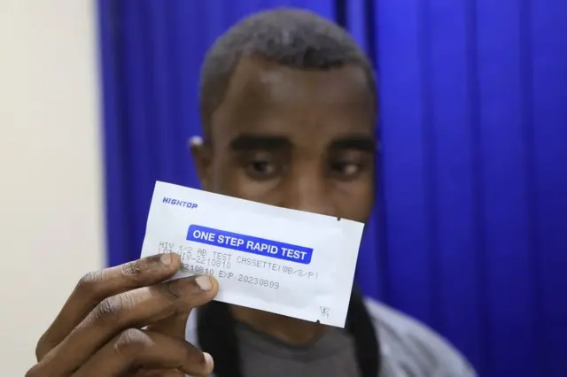  A man holds an HIV test in Harare, Zimbabwe, on October 21, 2022.
