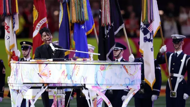 Jon Batiste become di first musician to perform di US National Anthem for di Super Bowl in front of a sitting president
