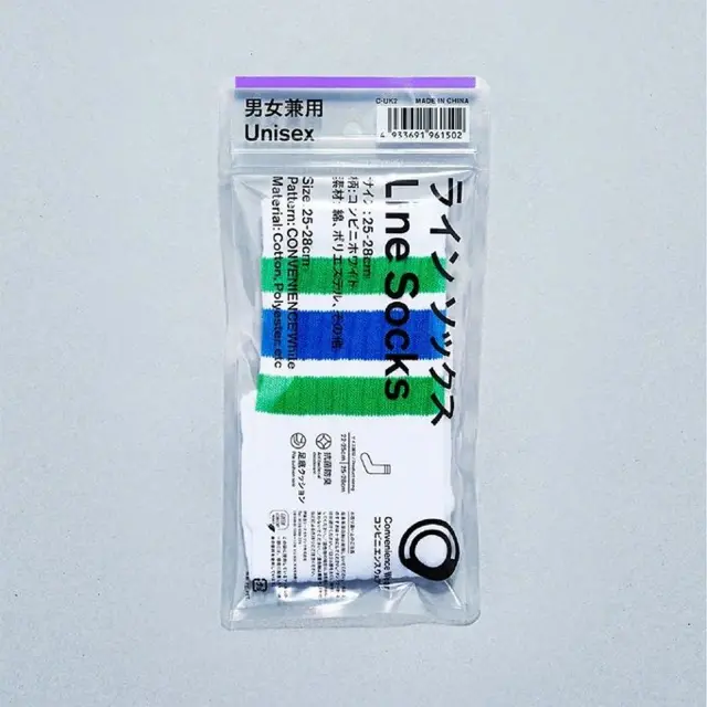 Білі шкарпетки з блакитними та зеленими смугами в пластиковій упаковці