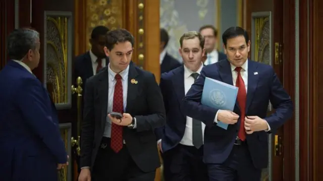 ABD heyetine başkanlık eden Dışişleri Bakanı Marco Rubio ceketini ilikliyor