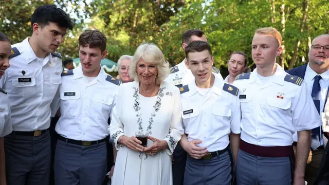 Queen Camilla poses with military cadets at the garden party