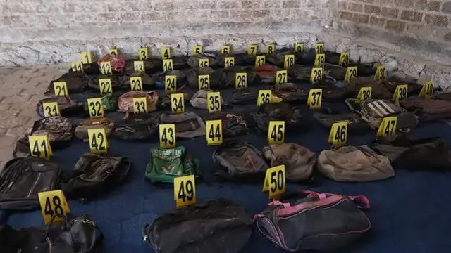 በስፍራው የተገኙ ቦርሳዎች መሬት ላይ ተደርድረው እና እስከ 50 ድረስ ቁጥር ተሰጥቷቸው