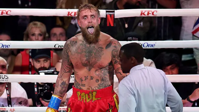 Jake Paul sticks his tongue out in the ring
