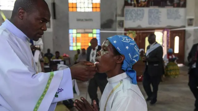 A worshipper receiving communion in Kenya