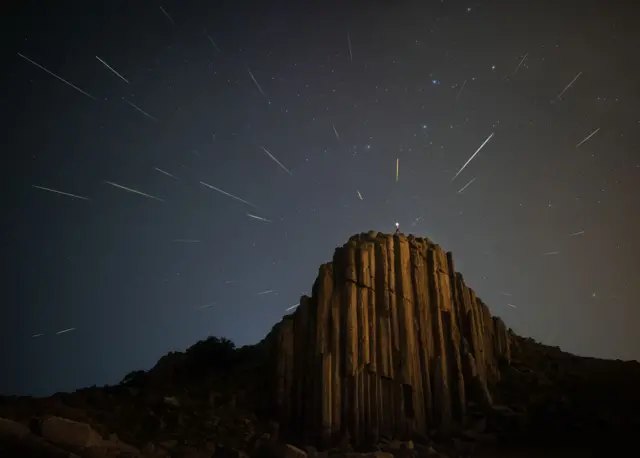 Streaks of meteros seen above a cliff-top in Baochang County, Inner Mongolia, China on 13 August 2021