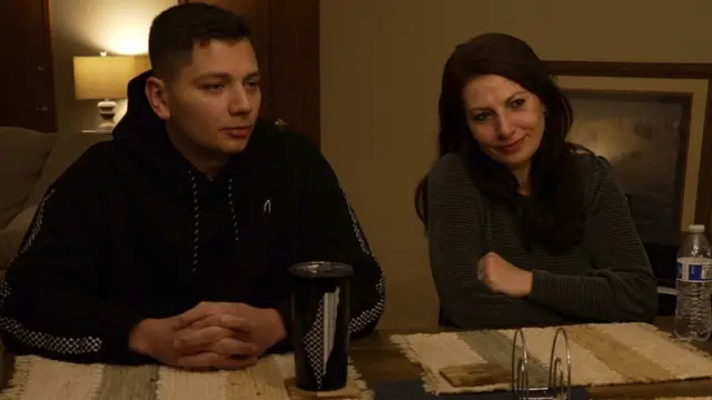 William Asfour and his mother Etaf Asfour seated at their dinner table