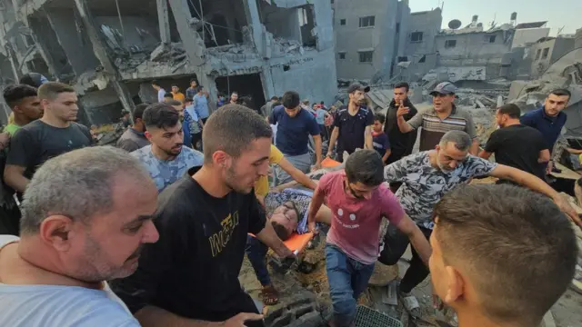 Rescuers carry a man on a stretcher from the aftermath of the 31 October Jabalia attack
