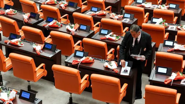 Bir Genel Kurul çalışanı Cumhurbaşkanı Erdoğan'ın konuşma metnini boş CHP sıralarına bırakıyor.