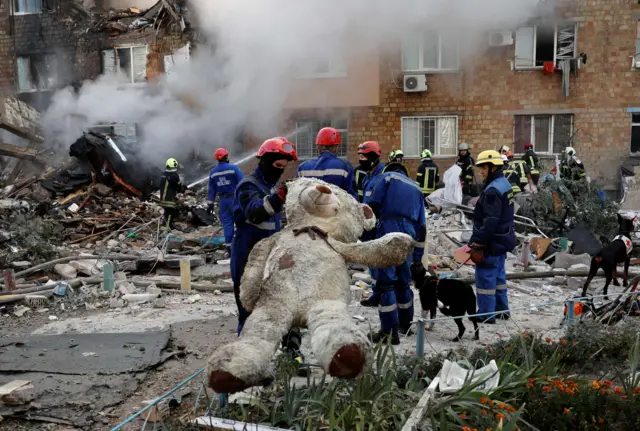Ratownik trzyma pluszową zabawkę po ataku rosyjskich rakiet i dronów w Kijowie