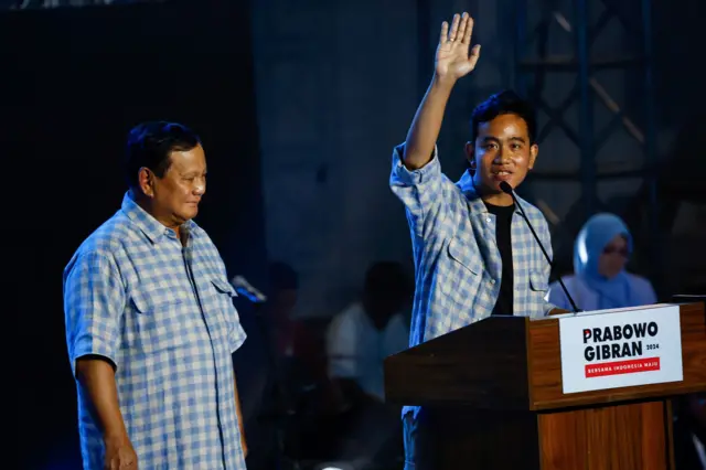 ice President candidate Gibran Rakabuming Raka gestures to his supporters as Presidential candidate Prabowo Subianto claims victory after unofficial vote counts during an event to watch the results of the general election in Jakarta, Indonesia,