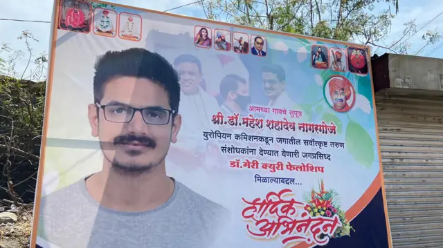 महेश यांच्या अभिनंदनाचं गावात लावण्यात आलेलं बॅनर.