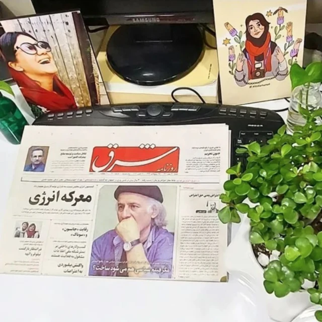 عکس یکی از روزنامه‌نگاران دستگیرشده در کنار روزنامه شرق