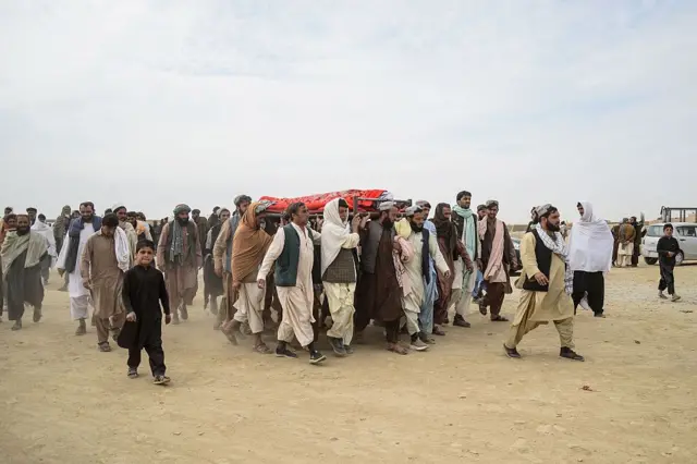 حمل پیکر یکی از جان‌باختگان توسط شهروندان در ولسوالی اسپین‌بولدک