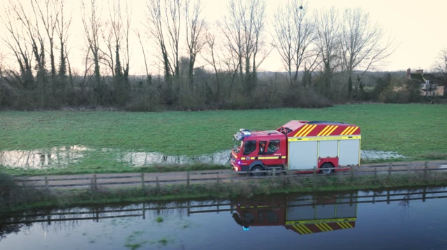 El vehículo de rescate especializado se ve viajando a través de un terreno inundado.