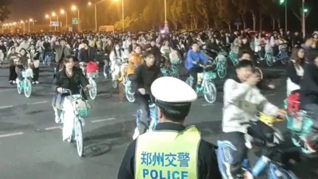 Thousands of students participate in a bike ride to Kaifeng, in search of soup dumplings, causing a highway to be clogged in Zhengzhou, Henan, China this screen grab obtained from social media video released November 9, 2024.