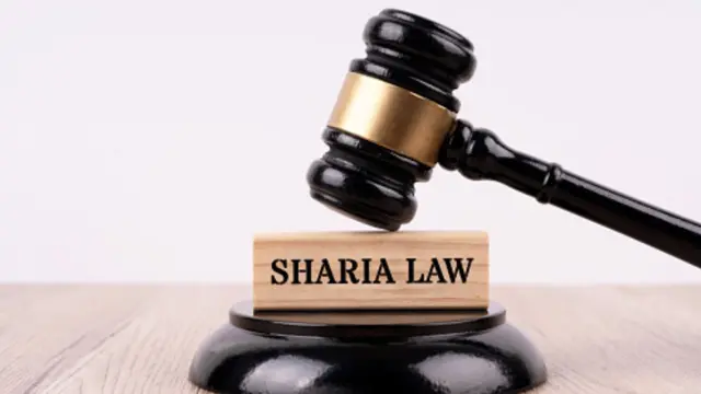 Gavel on top one sharia law inscription
