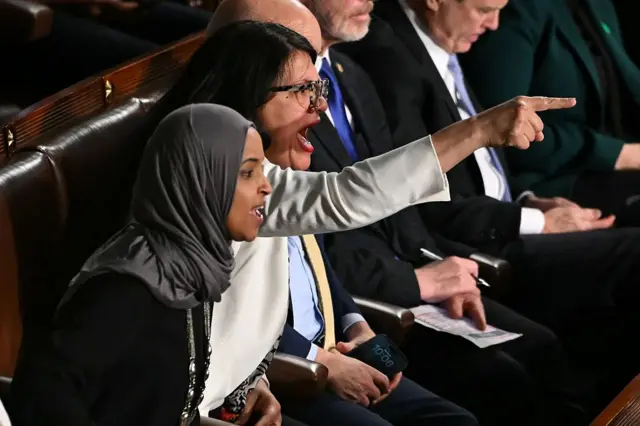 US Representatives Ilhan Omar, Democrat from Minnesota, and Rashida Tlaib, Democrat from Michigan, shout as President Donald Trump delivers the State of the Union address in the House Chamber of the US Capitol in Washington, DC, on February 24, 2026. (Photo by ANDREW CABALLERO-REYNOLDS / AFP via Getty Images)