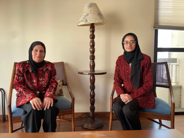 Nawal Abujayyab e Lozan sentadas em sala, posando para foto com sorrisos contidos