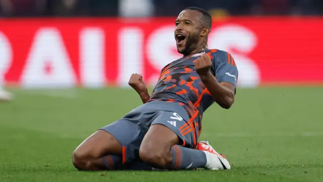 Ayoub El Kaabi slides on his knees as he celebrates a go