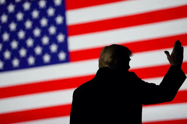 Former U.S. President Donald Trump gestures during a rally in Conroe, Texas, U.S., January 29, 2022.