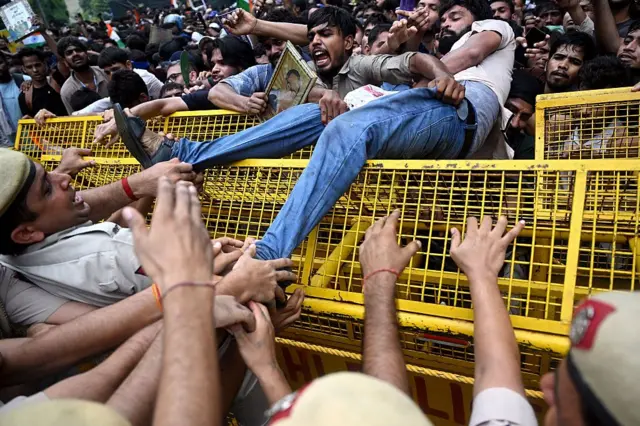 Activists and supporters of the Cockroach Janta Party (CJP) clash with police personnel during a protest demanding the resignation of India's Education Minister Dharmendra Pradhan over alleged NEET examination irregularities in New Delhi on July 20, 2026. India's riot police baton-charged protesters in New Delhi as they tried to march to parliament on July 20, escalating a protest over irregularities in major examinations.