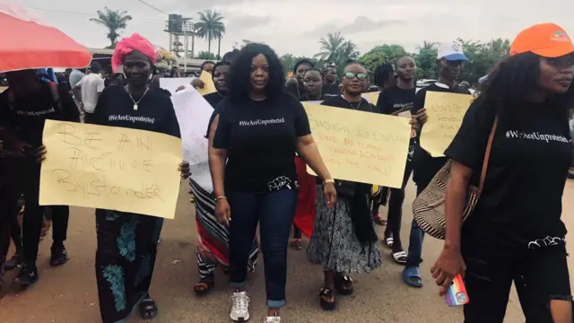 Miatta Gray marches alongside other women