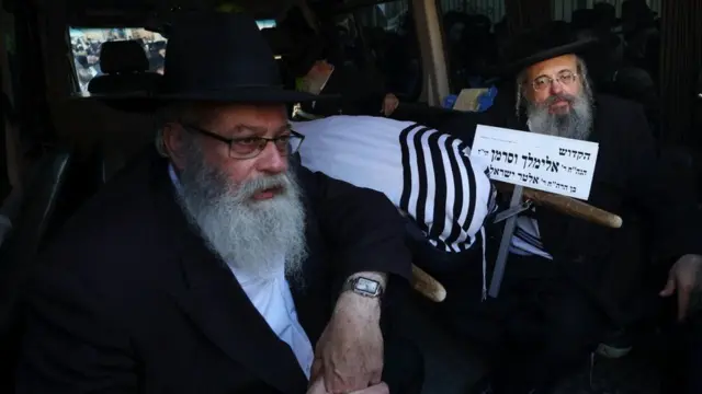 Two men in a hearse mourning rabbinical judge Elimelech Wasserman, who was killed in a shooting attack when Hamas gunmen opened fire at a bus stop at the entrance to Jerusalem on 30 November 2023