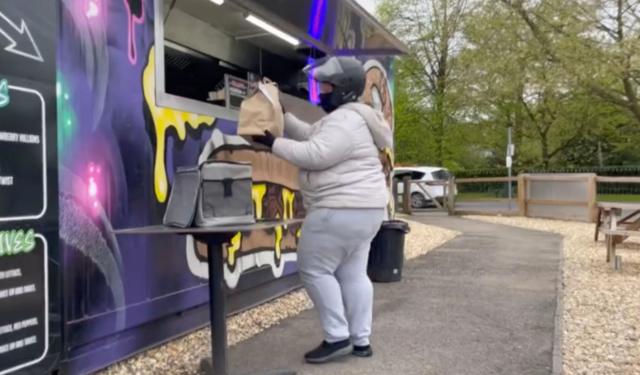 Mulher pegando lanche em food truck