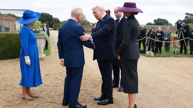 King Charles III and Queen Camilla receive US President Donald Trump and First Lady Melania Trump for Windsor Castle for Windsor, Berkshire, on day one of dia second state visit to di UK. Queen Camilla dey wear blue outfit while odas dey wear black outfits wit cameramen for di far right