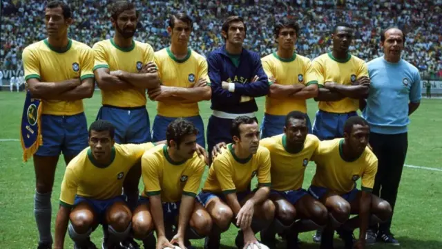 منتخب البرازيل في كأس العالم عام 1970 في الملعب ويرتدون قمصان صفراء أكمامها قصيرة.