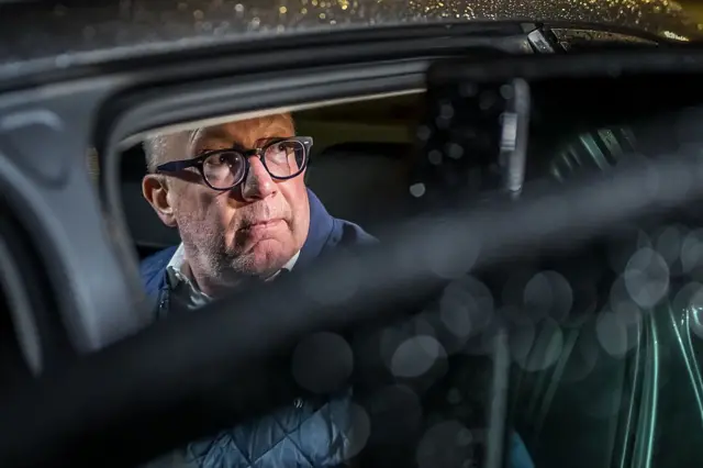Mayor of Crans-Montana Nicolas Feraud looks out from a car leaving an hearing as part of the investigation over the fire that broke out in the bar "Le Constellation" during New Year celebrations, claiming 41 lives, most of them teenagers, and injuring 115 others, in Sion, western Switzerland, on April 13, 2026. (Photo by Fabrice COFFRINI / AFP via Getty Images)